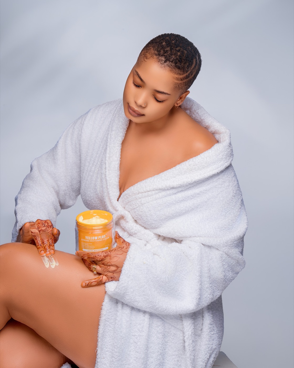 Customer applying Yellow Plus cream to her skin